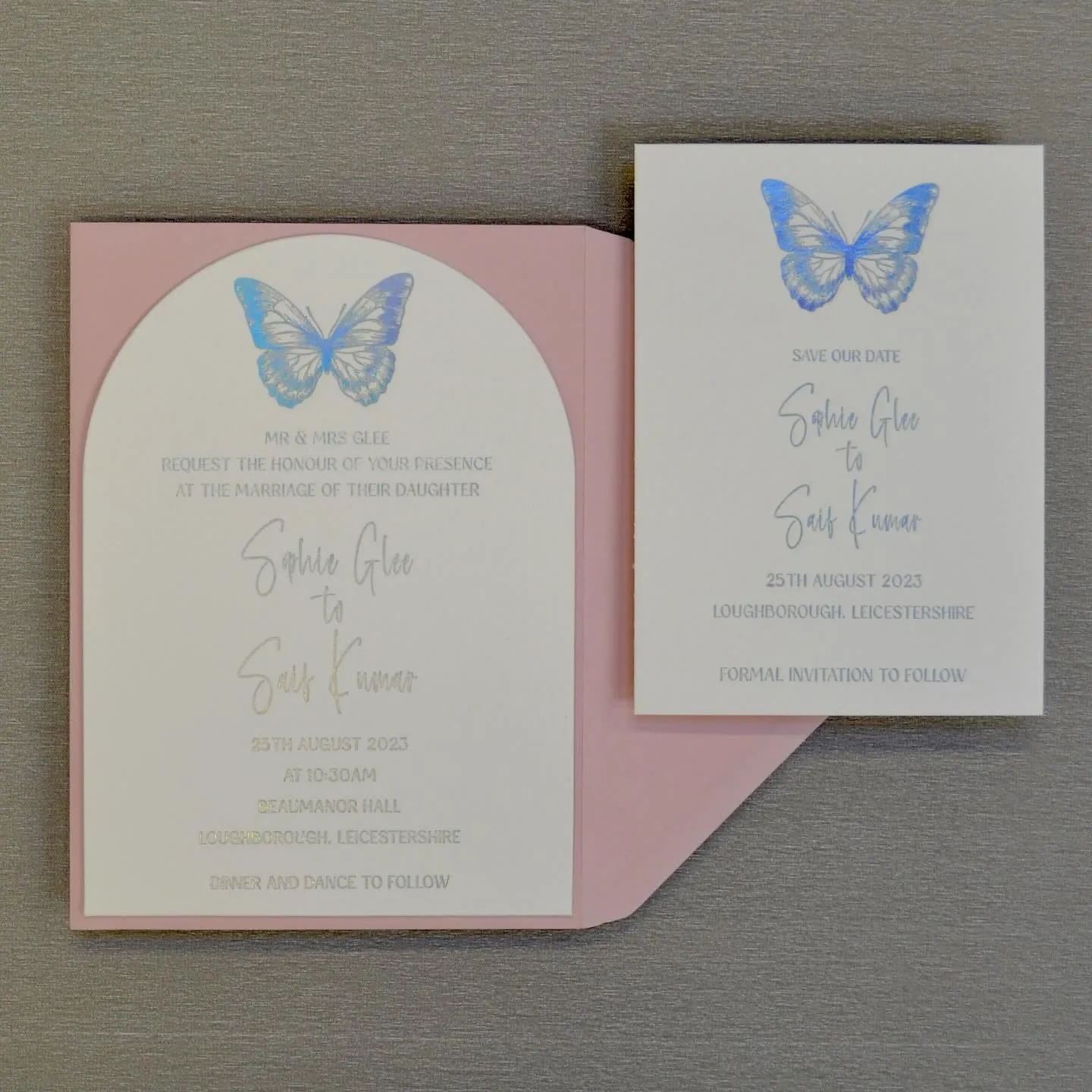 The Butterfly invitation and its matching save the date side by side, both with a blue foiled butterfly and silver foiled names.